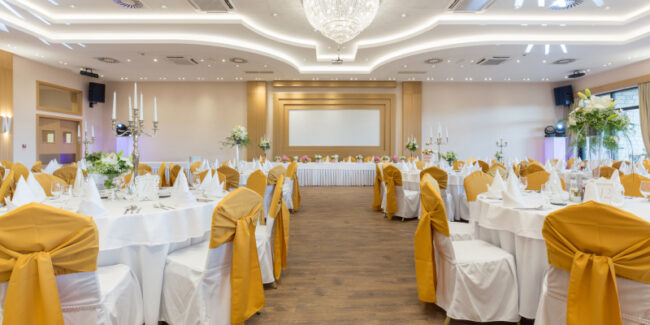 "A beautifully decorated banquet hall illustrates the things to consider when selecting a banquet hall. "