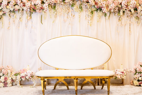 A banquet hall decorated with flowers is set for an engagement party.